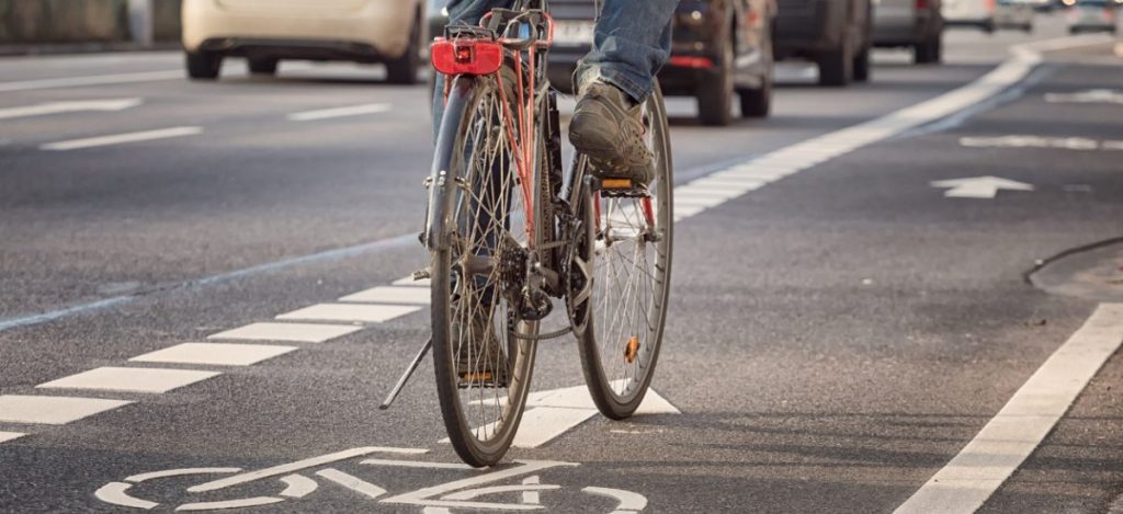 Injured cyclist in bike lane after accident with car
