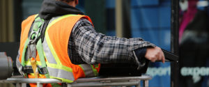 Construction worker handling metal