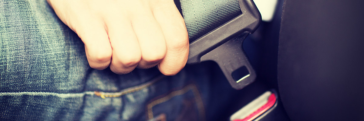Close up of hand fastening seat belt