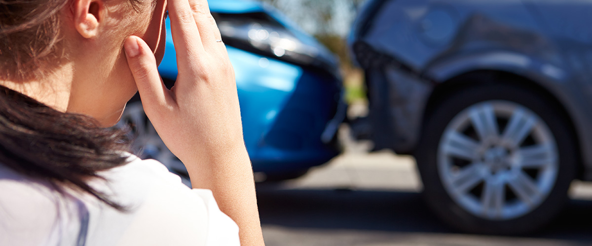 Woman looking at car accident