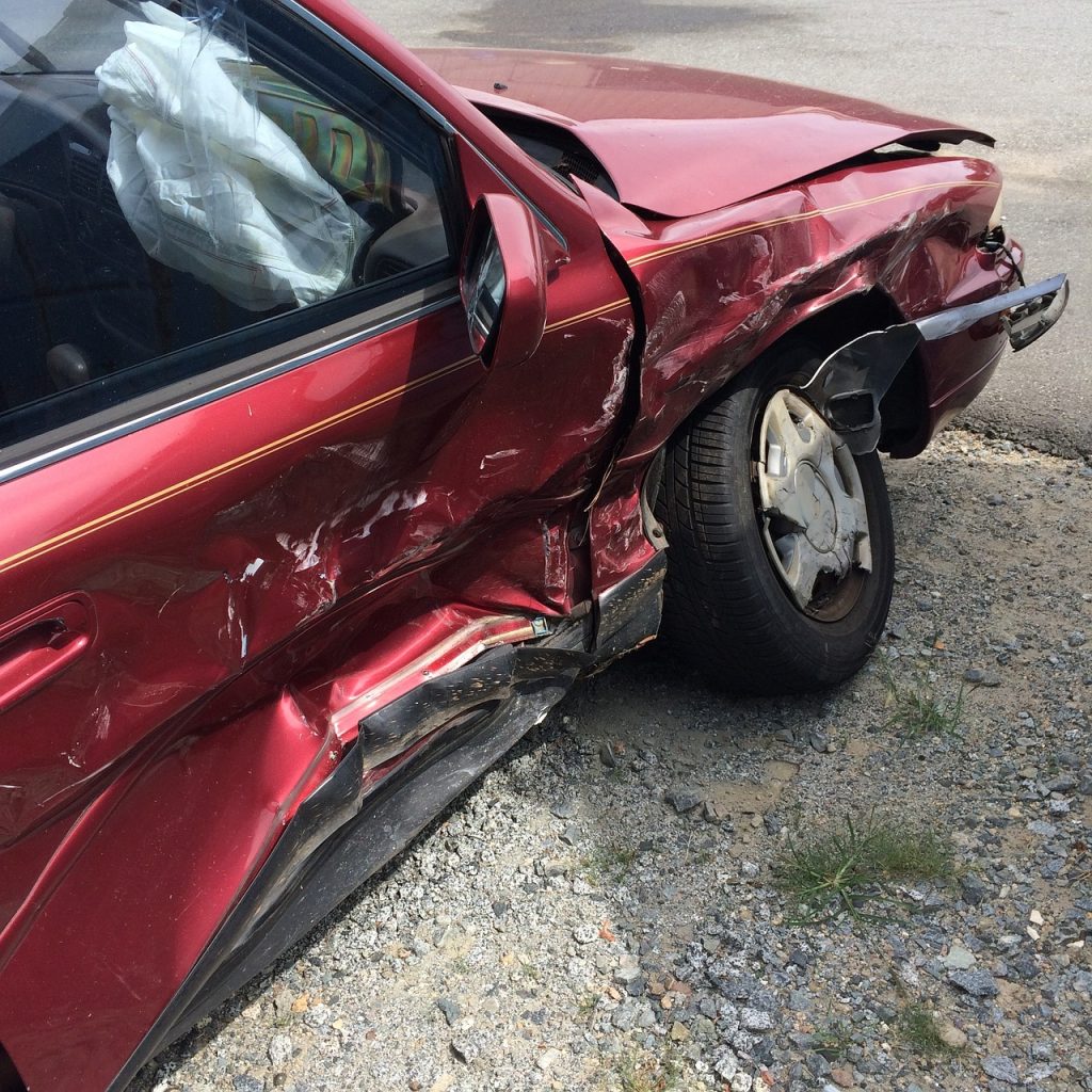 A red car has been damaged in a crash. - Olympia Hit and Run Accident Lawyers