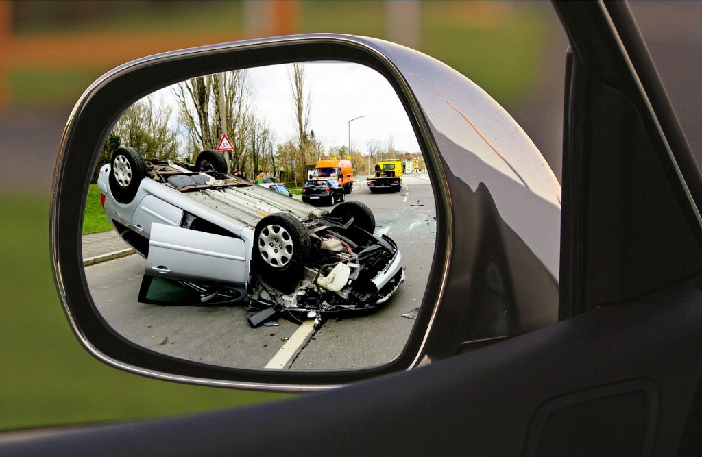 a rear view mirror with a car on it - Car Accident Cases