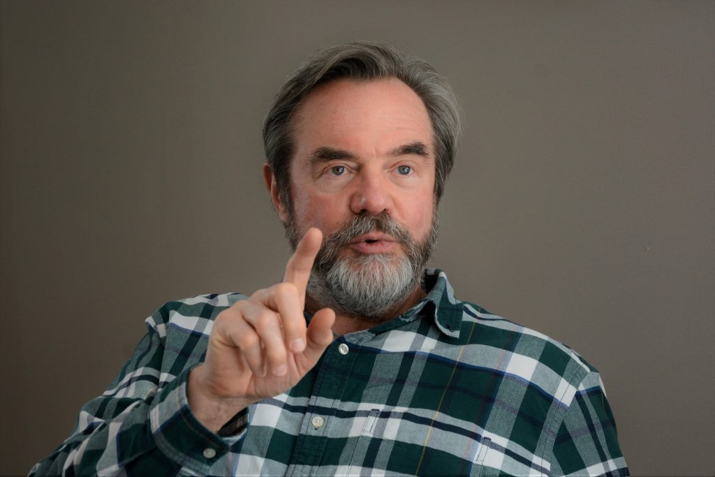 a man with a beard pointing at something - personal injury attorney