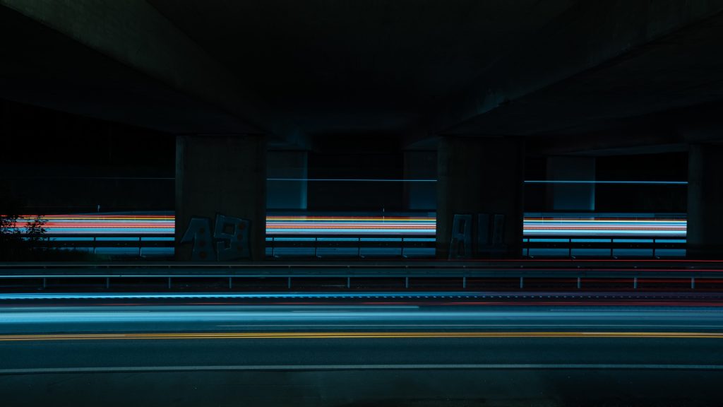 a blurry photo of a car going under a bridge - Vehicle Accident Investigations