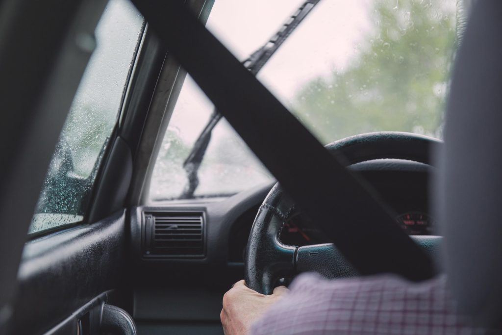 a man driving a car on a rainy day - Accident Legal Challenges in Minnesota