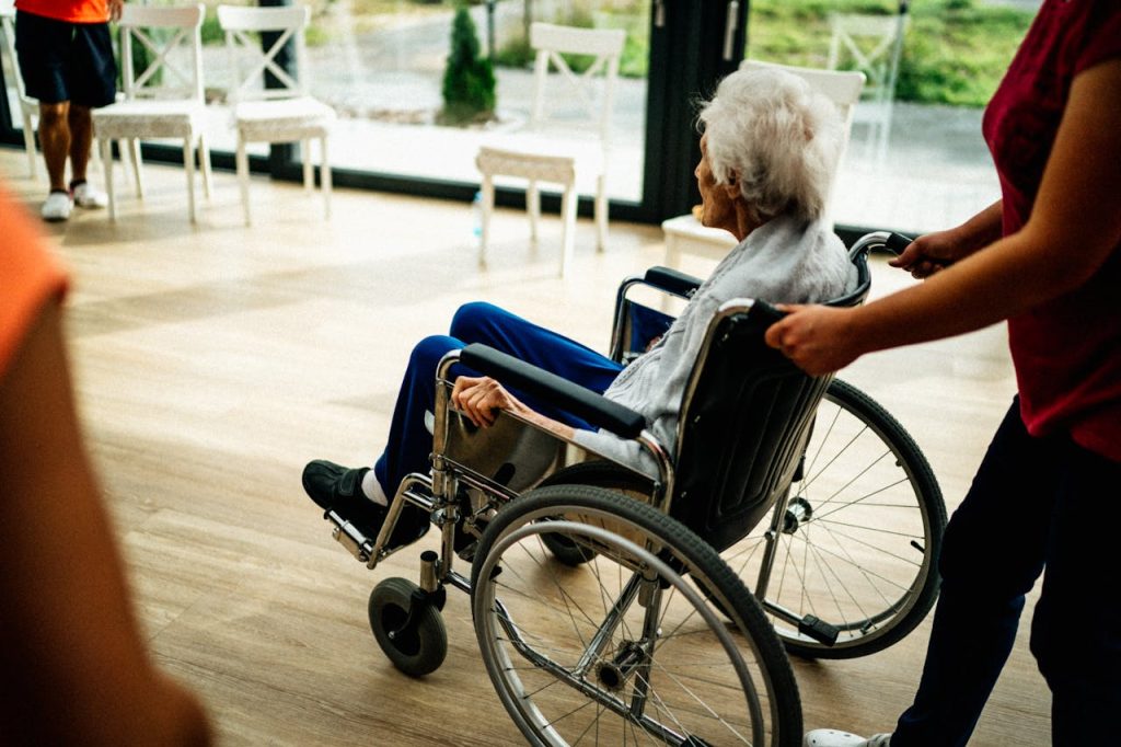 Nursing home staff assisting senior resident – preventing neglect through federal reform laws