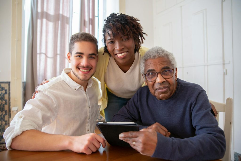 Elderly resident smiling while spending time with visiting family